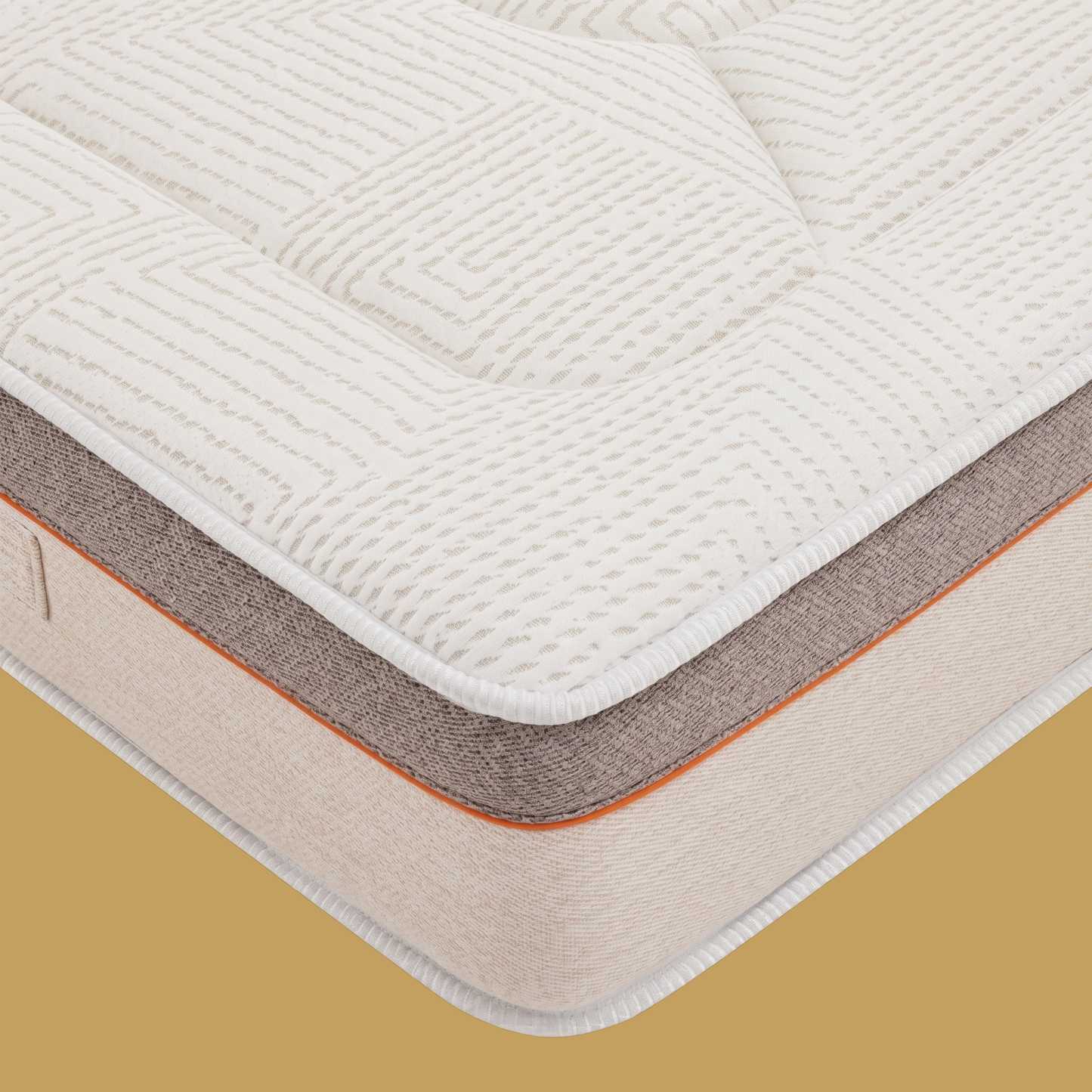 Détail du coin de matelas Bultex haute qualité, tissu jacquard blanc matelassé géométriquement, bordure technique bicolore gris-beige avec liseré orange et étiquette tissée de marque visible.