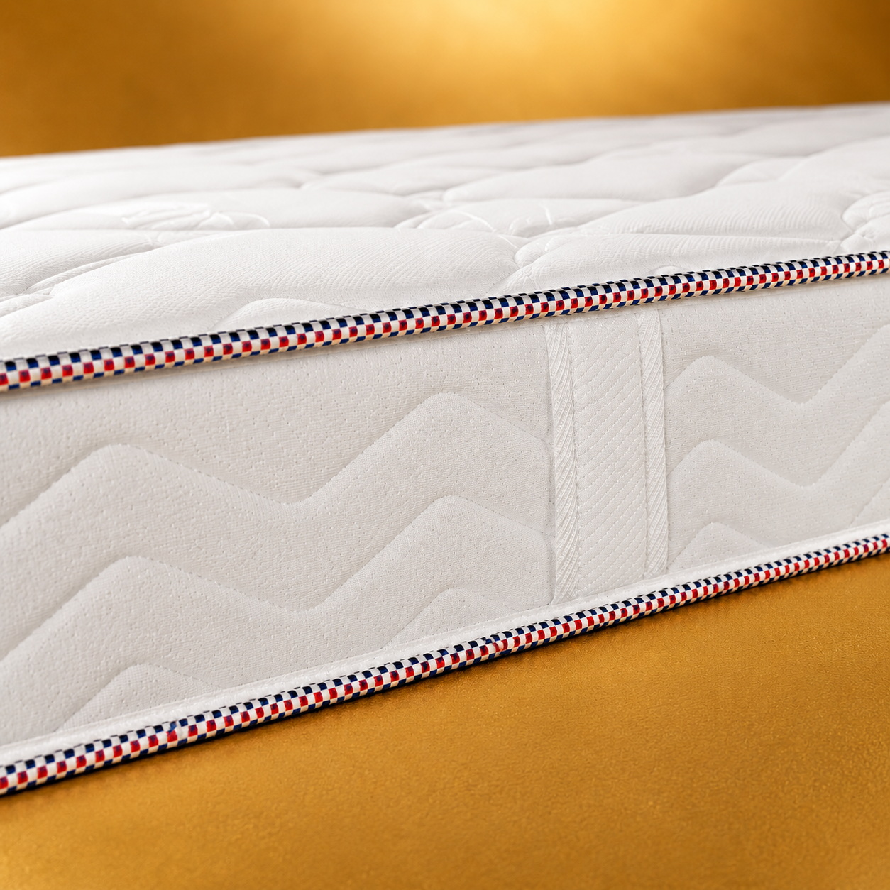 Détail du matelas Bultex DUNK Hydrofriend 19 cm avec coutil matelassé et finition tricolore